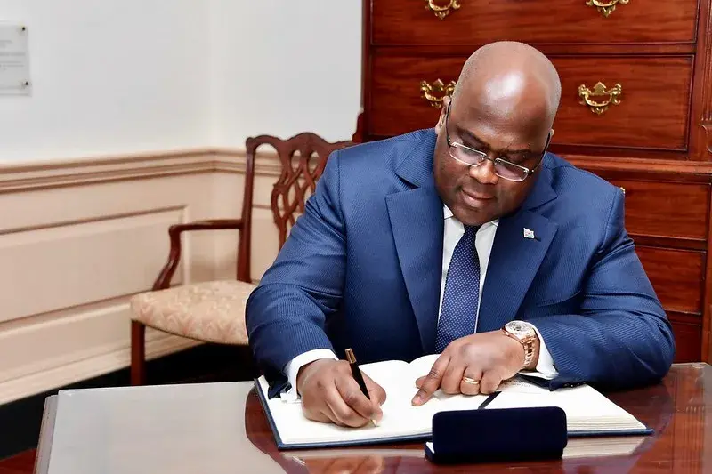 Tshisekedi signing a book. He was confirmed as re-elected president by DR Congo Constitutional Court