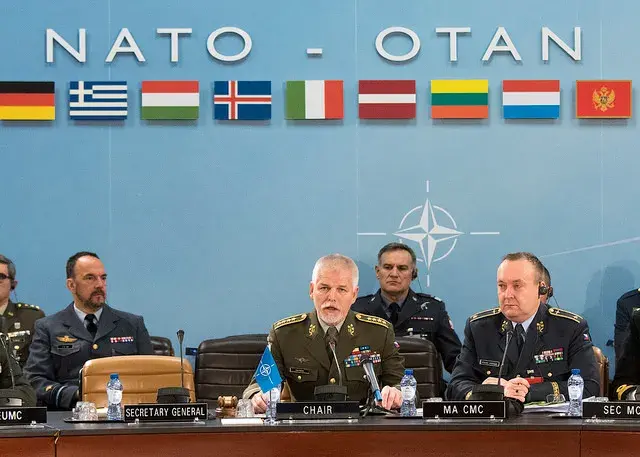 NATO military leaders sitting around a table.