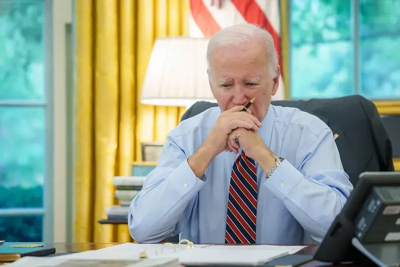 President Joe Biden sitting and thinking with the gaze down.