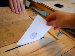 Electoral envelope entering the ballot box.