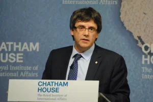 Carles Puigdemont speaking at a conference.