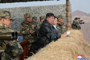 Kim Jong Un supervising a military exercise with his daughter.