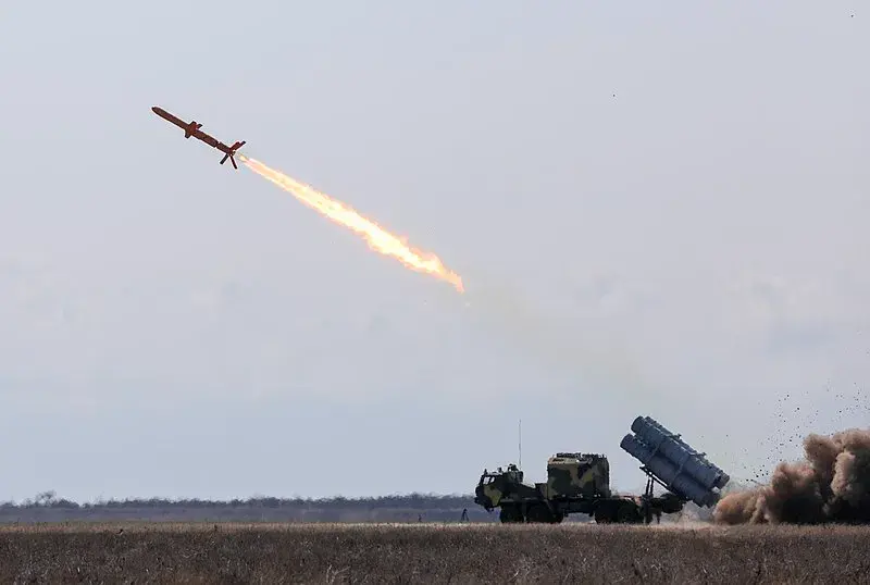 Ukrainian cruise missile being fired from a platform in the open field.