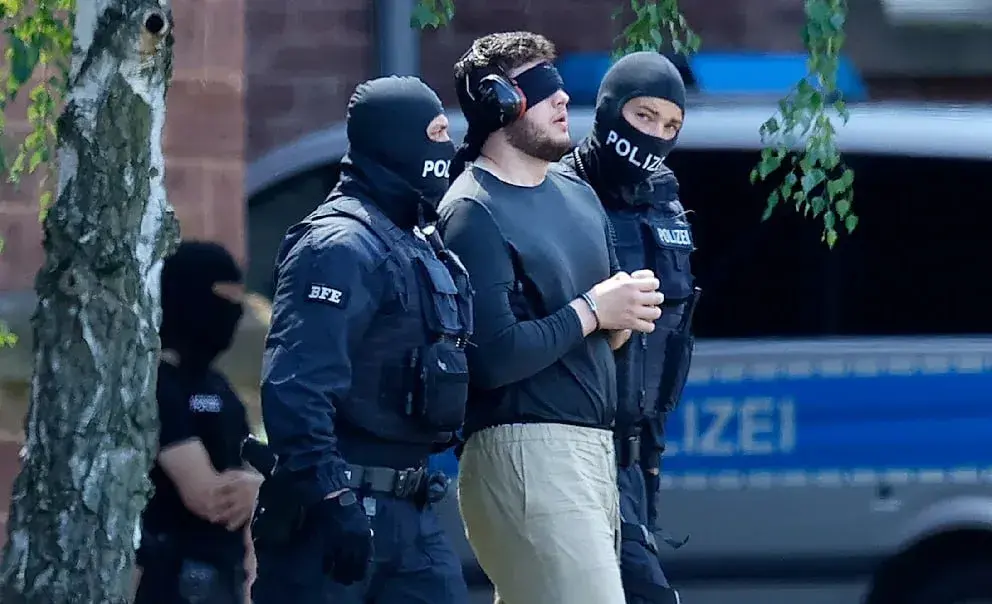 German police arresting a suspect of planning terrorist attacks.