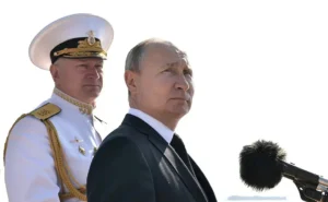 Now dismissed Admiral Nikolai Yevmenov, behind Russian President Vladimir Putin.