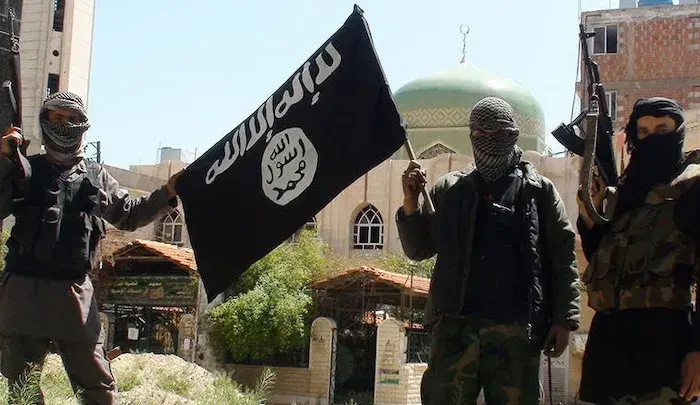 ISIS fighters showing a flag of the group.