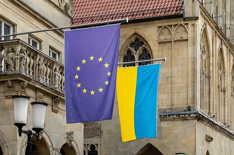 A flag of the EU next to a flag of Ukraine.