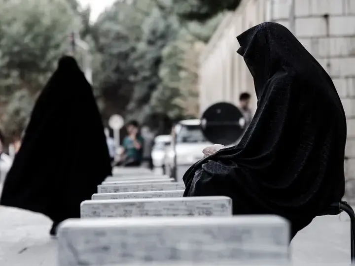 Women covered with black Islamic veil.