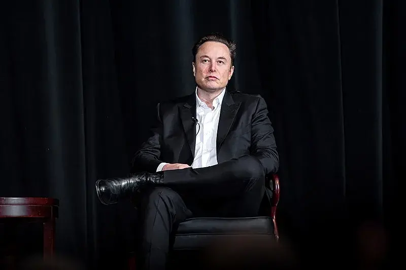 Elon Musk sitting.